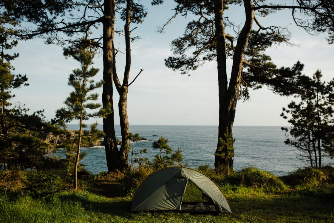 Tent on a cliffside overlooking the pacific ocean