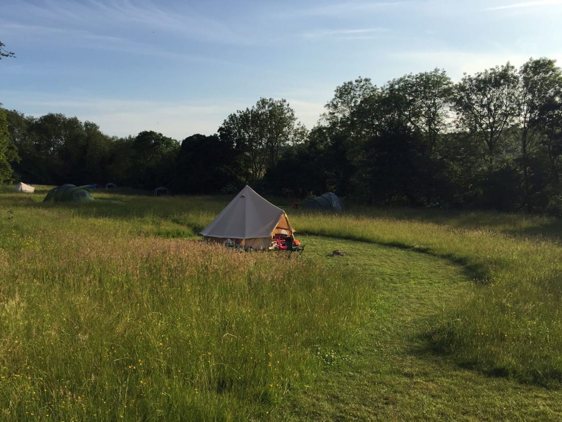 A convivial rural campsite with 15 pitches in a hilltop grassy meadow in the Garden of England. Play in the wildflowers, cook atop your campfire, or just plain chill.
