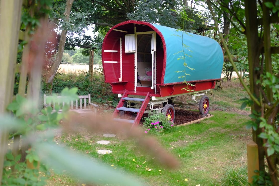 Gypsy Caravan tucked away at the end of the garden with a field behind
