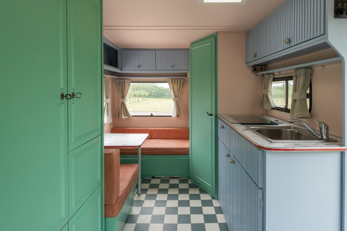 Beverley Thrills Caravan - Overview of the space featuring the wardrobe area, the dining room, door to the eco shower room and the kitchenette