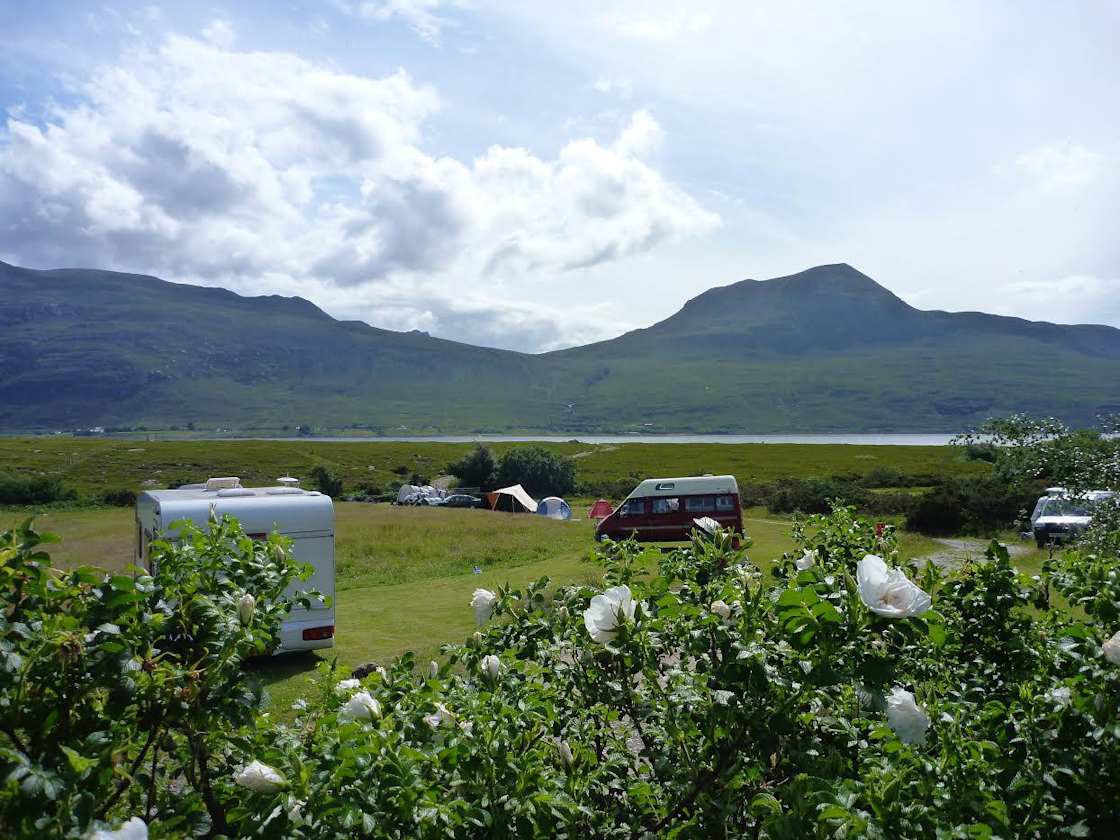 A grass pitch with Electric Hookup at Badrallach. Bring a campervan to this lochside loaction in Scotland, plug in and switch off!