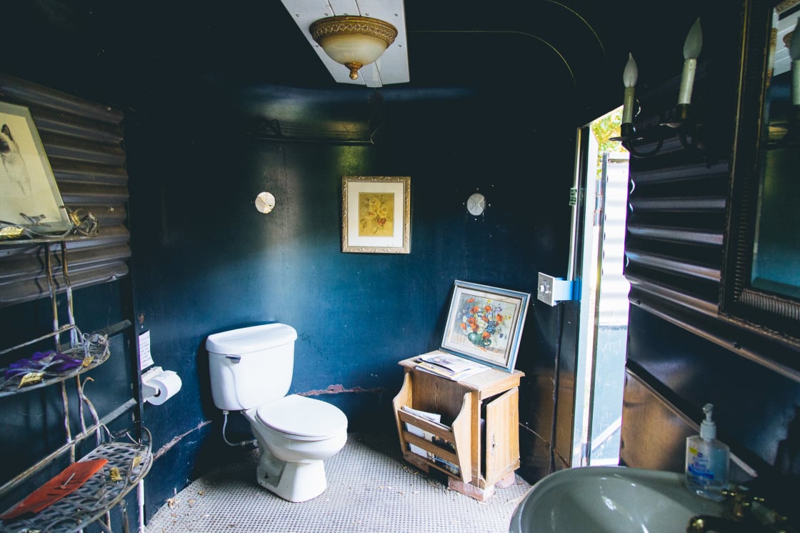 Inside the horse trailer converted into a fully functioning bathroom + sink. So unique!