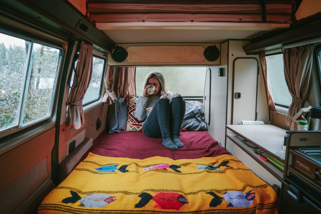 We cozied up in our camper van with a warm cup of coffee while the rain bounced off the roof. 