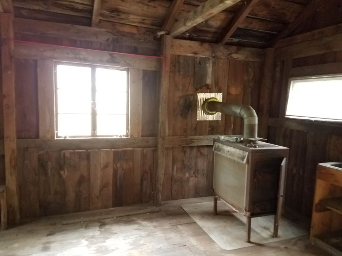 Cabin interior showing wood stove