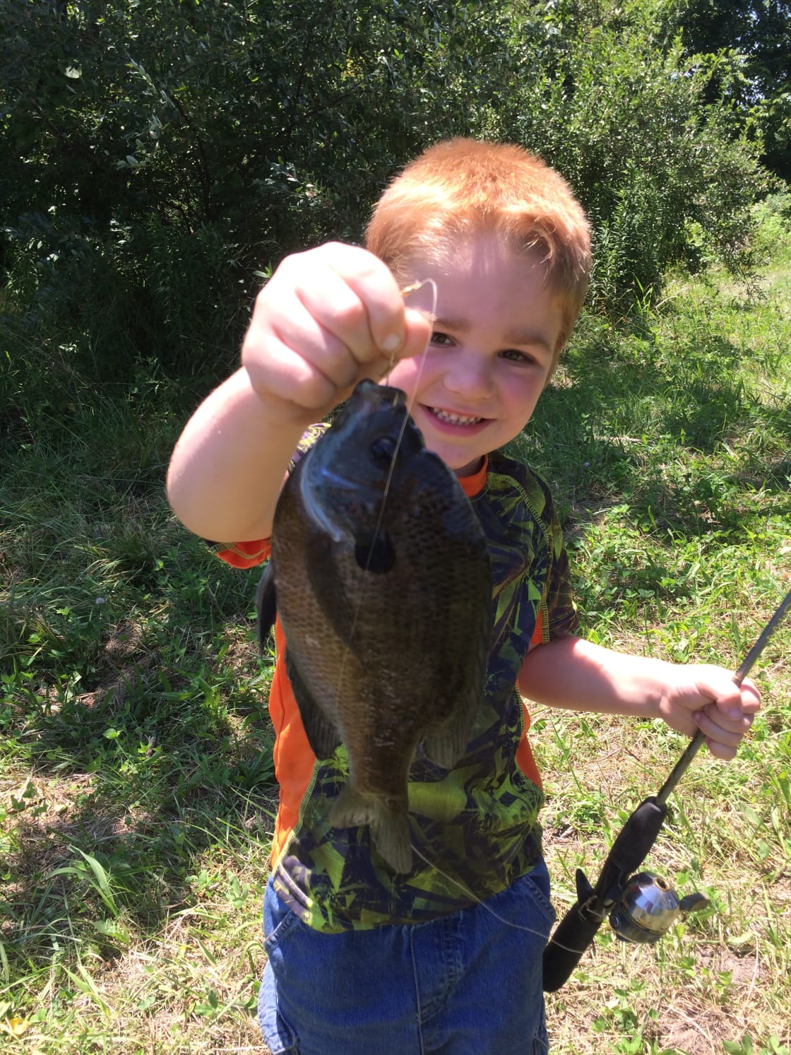 That's a big blue gill for a little boy.