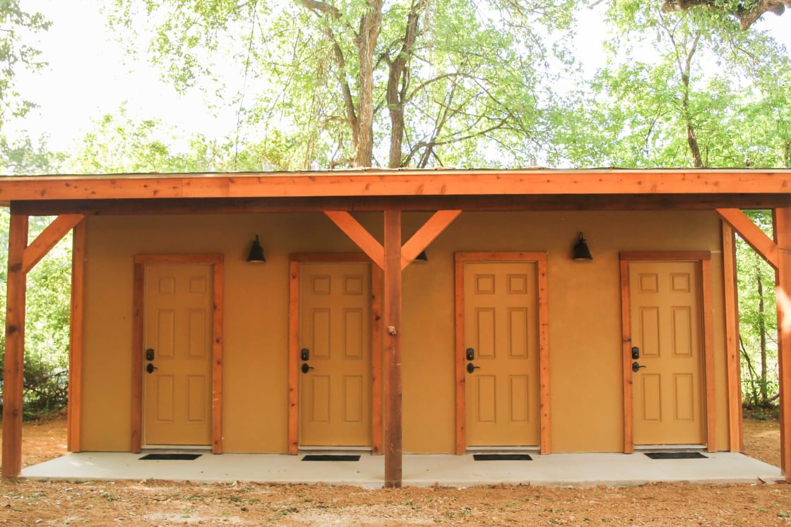Each tipi has its own bathroom. The bathhouse is located near the tipis.