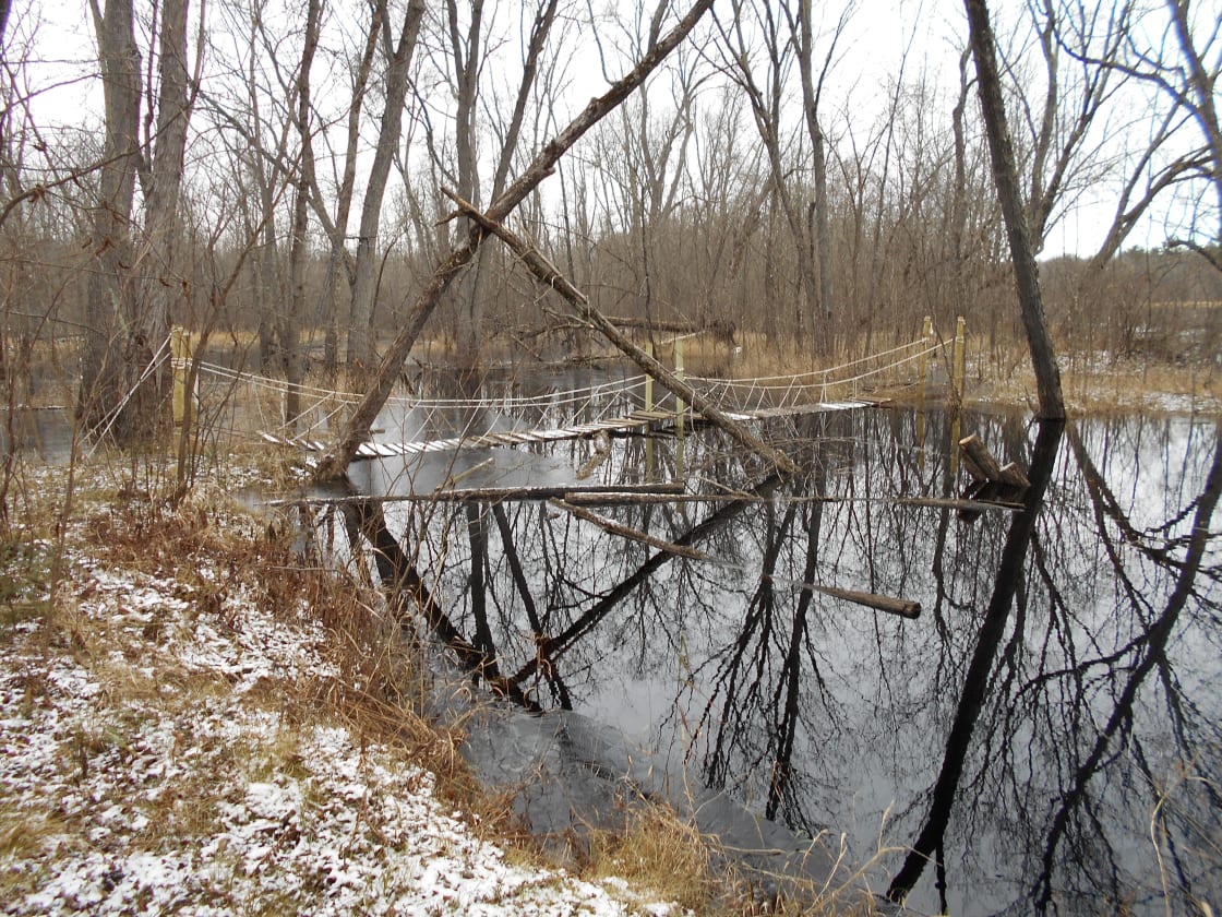 This is Maggie's Mirror that runs through the property. It is in flood stage. Picture was taken before Spring turned everything green. It also shows a cable bridge that my son and I built that crosses Maggie's Mirror to the stairway down to the Chippewa.