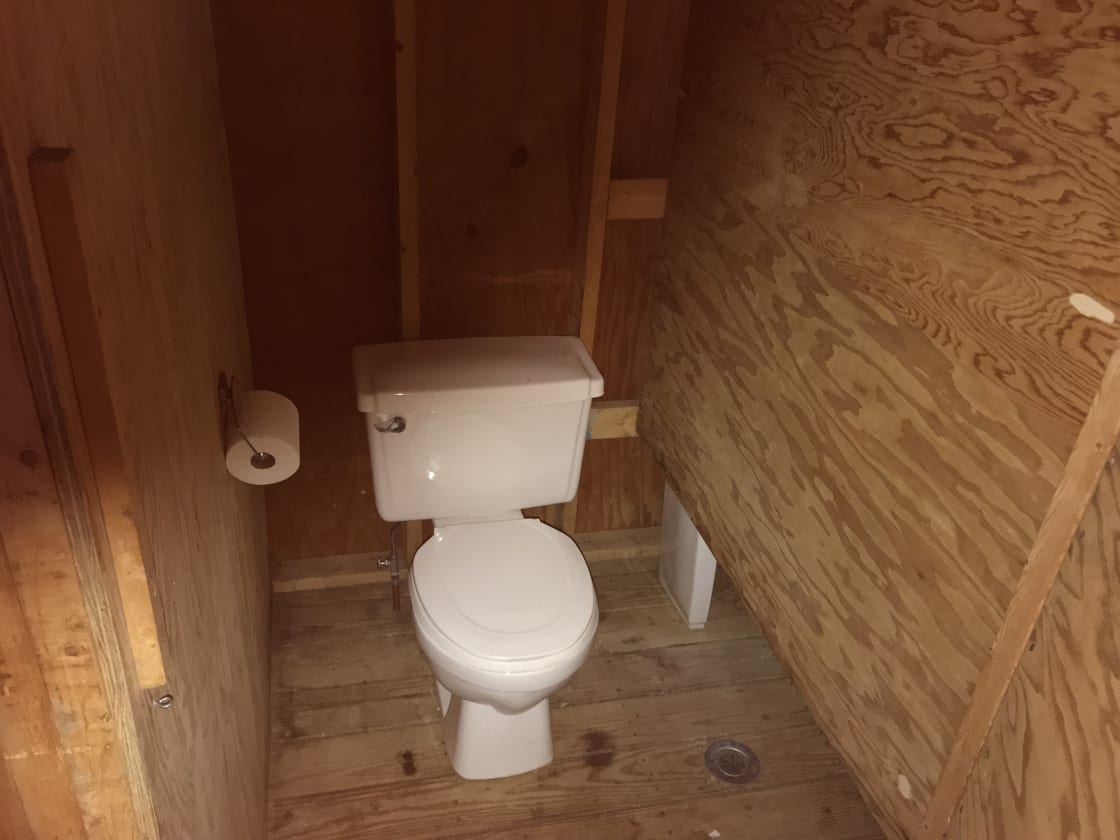 One of four flush toilets in bathhouse