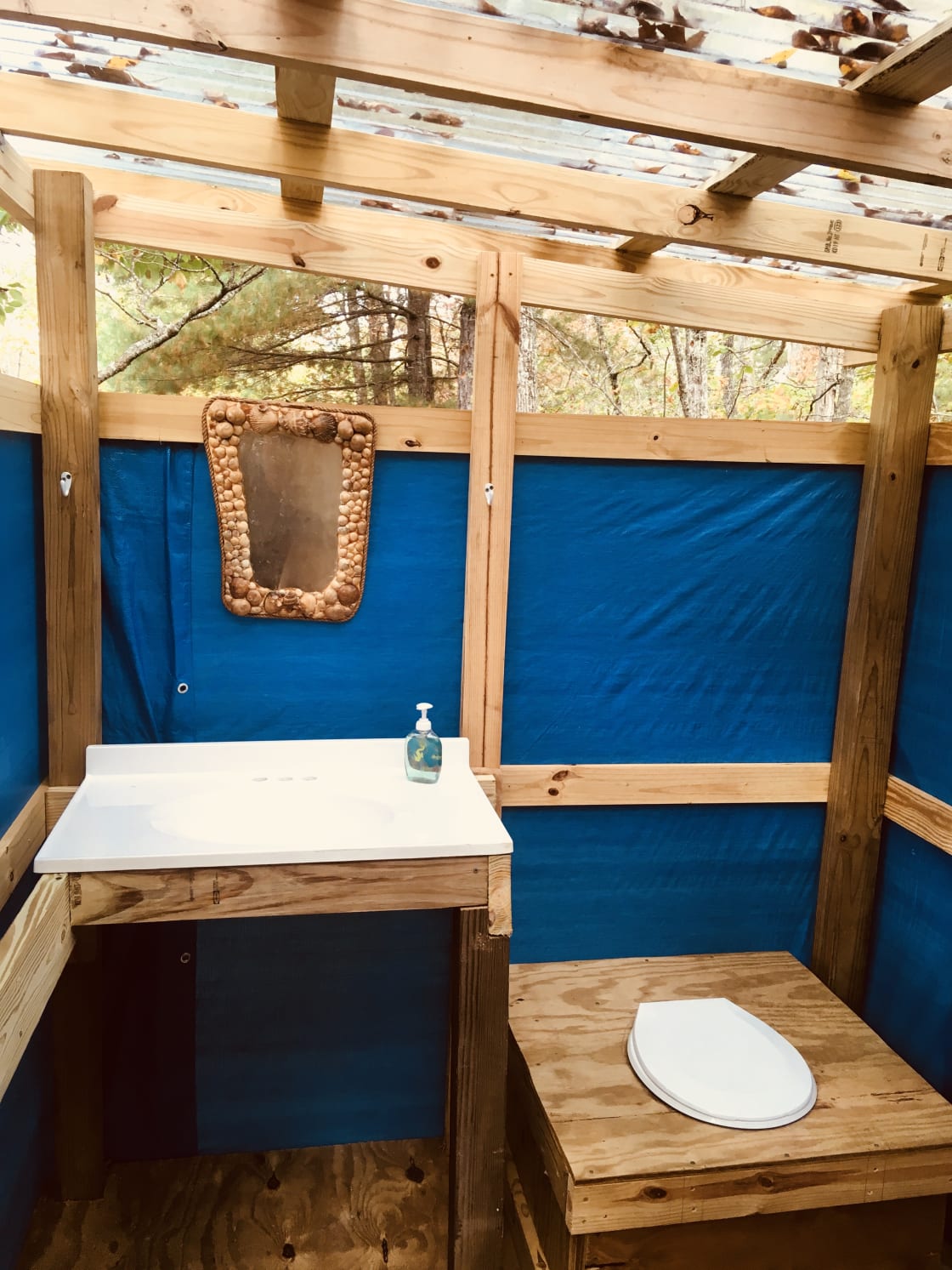 The composting pit toilet is open-air, but enclosed for privacy and has hooks galore to hang your important things.