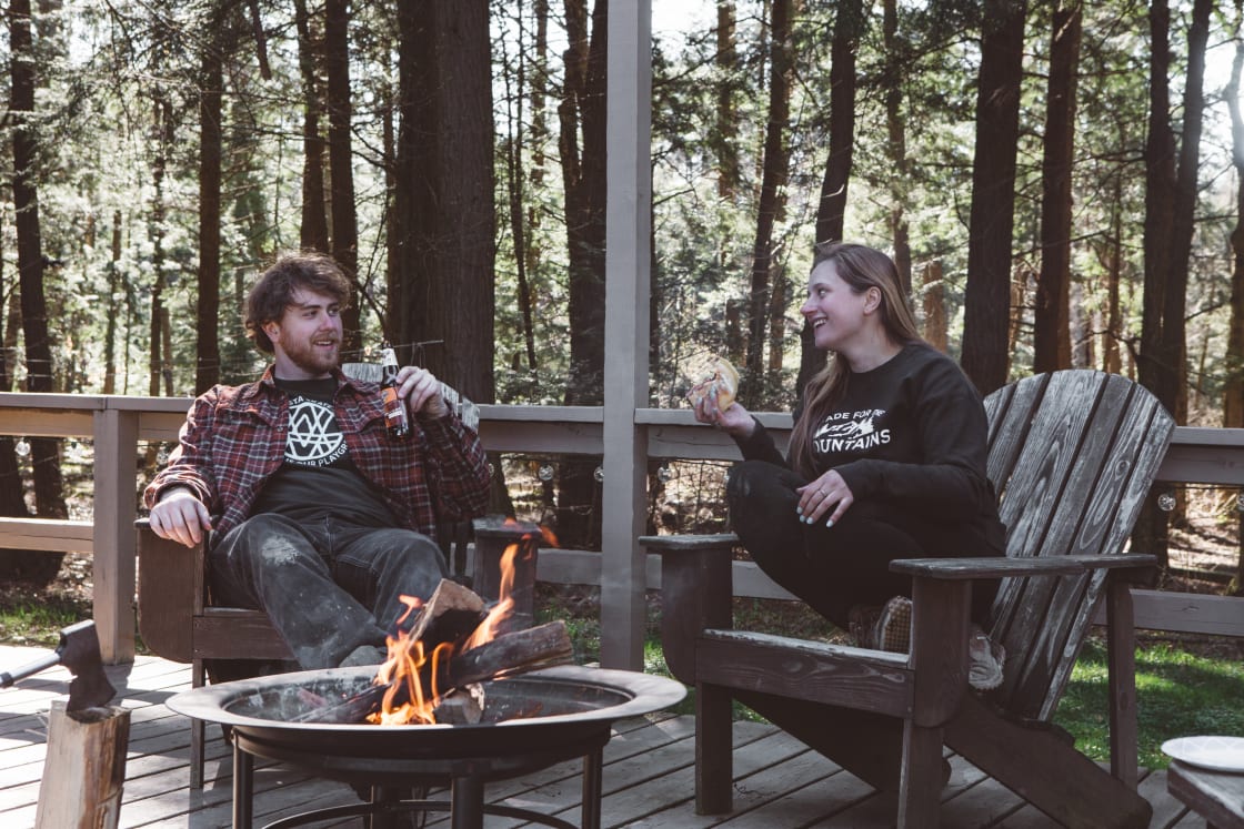 The patio off the back of the cabin provides a very relaxing spot to unwind with plenty of seating and a fire-pit.  