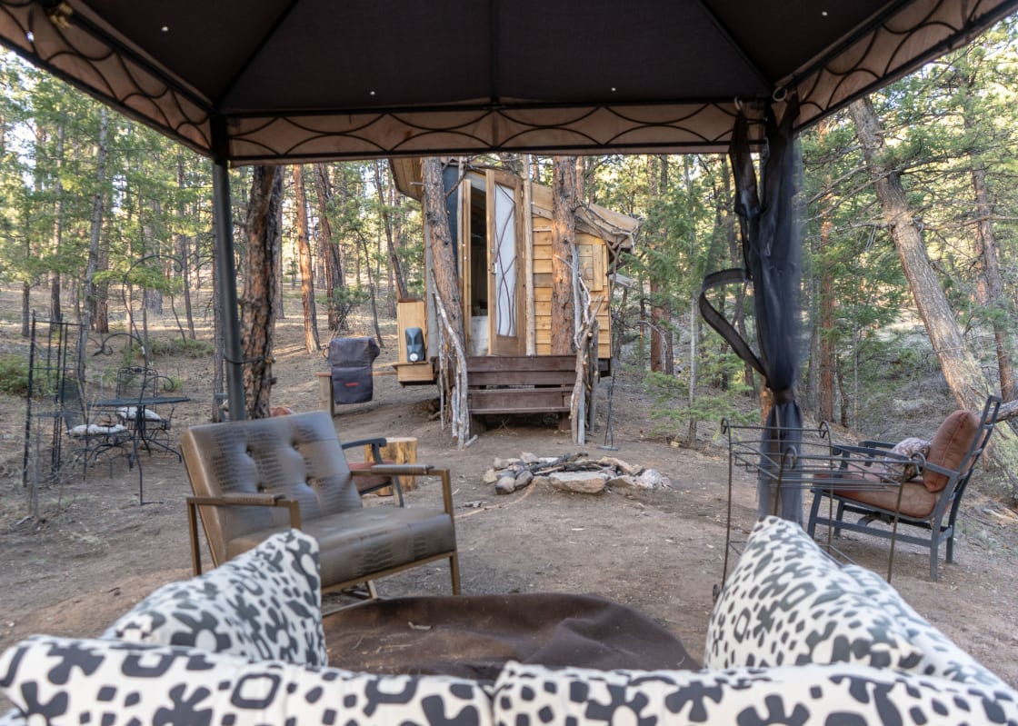 Complete with a sofa, a number of chairs, a tent and a firepit, this place has it all!