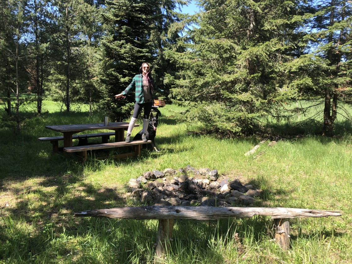 Here's Jessie showing off the picnic table and campfire pit at site 1.