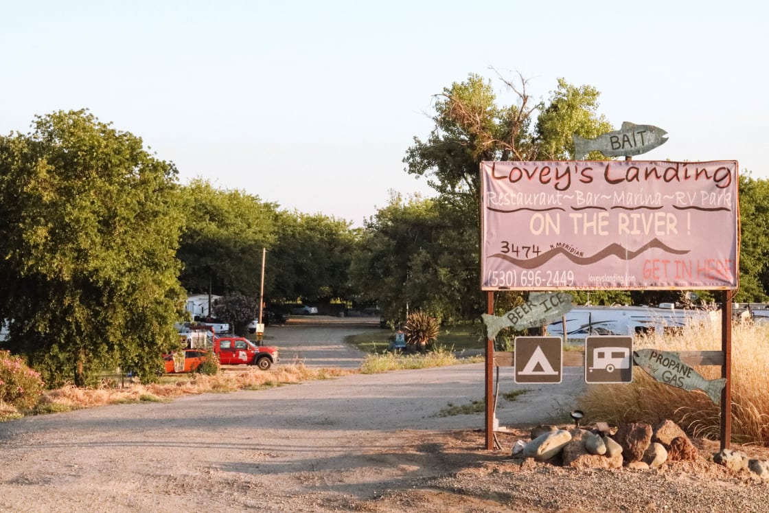The sign at the entrance of Lovey's Landing, tent camping parking is just on the left after the sign