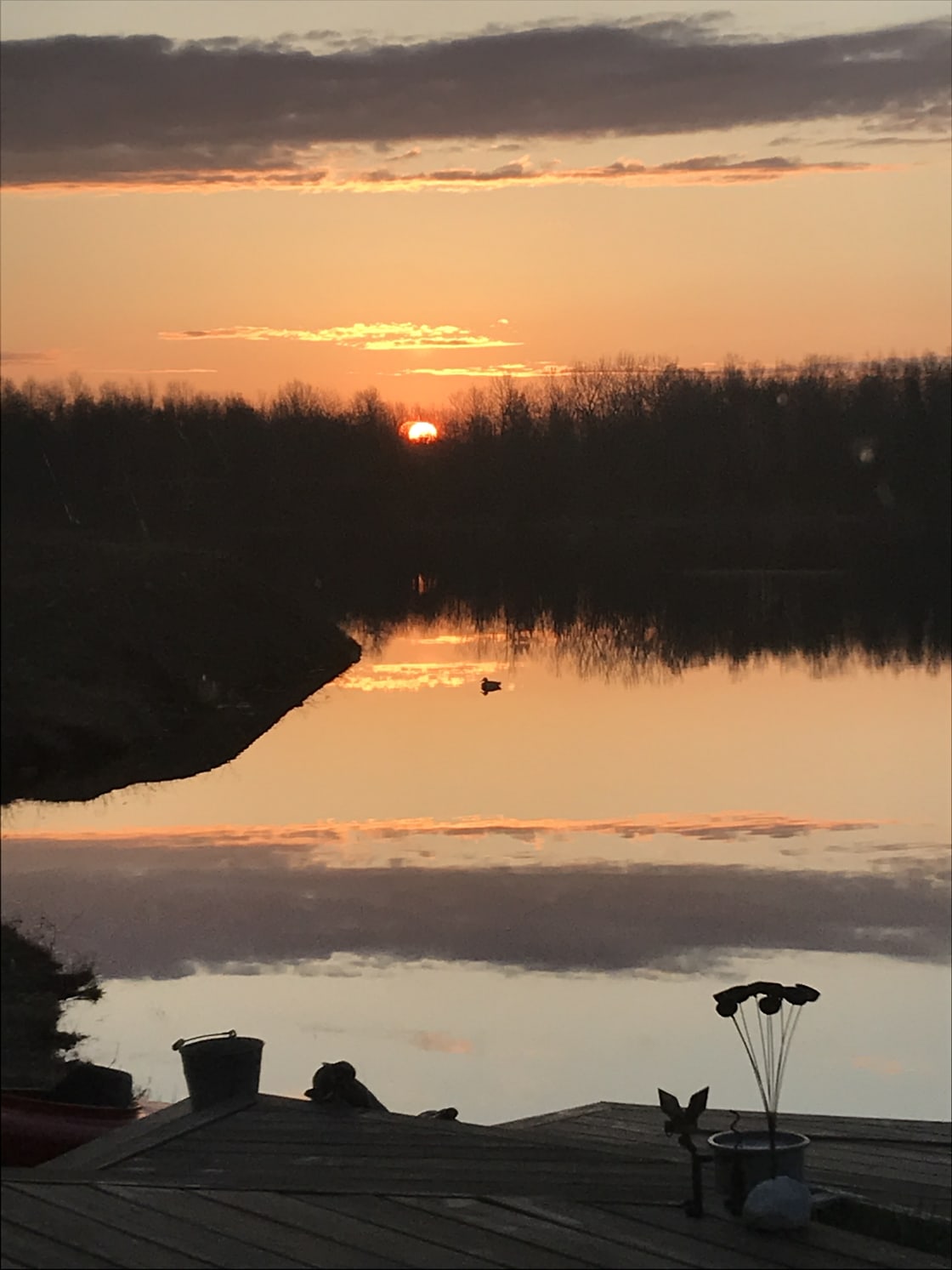 This sunrise view is looking across at the lake at the secluded forest where your RV can be parked. The rising sun marks your spot.