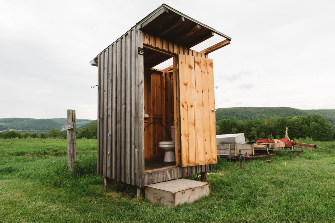 A home made outhouse sits at the top of the property for campers to use during their visit.  