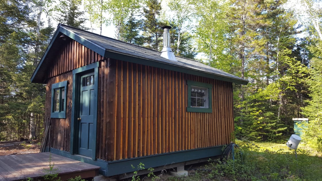 The Moose Moose: 12x16 standing-seam log cabin, sleeps 2 in bunks, has a small kitchen with running water from a frost hydrant, living room, table and chairs, keyed entry, has outdoor fire pit and outhouse. Use of Coleman stove available. 