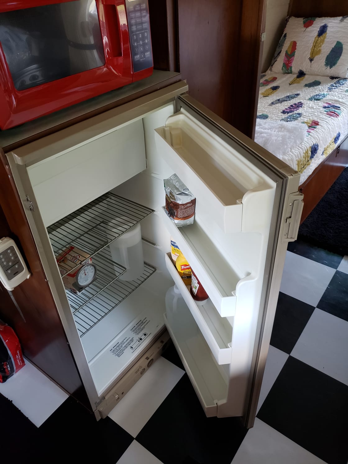 Small fridge with basic condiments.