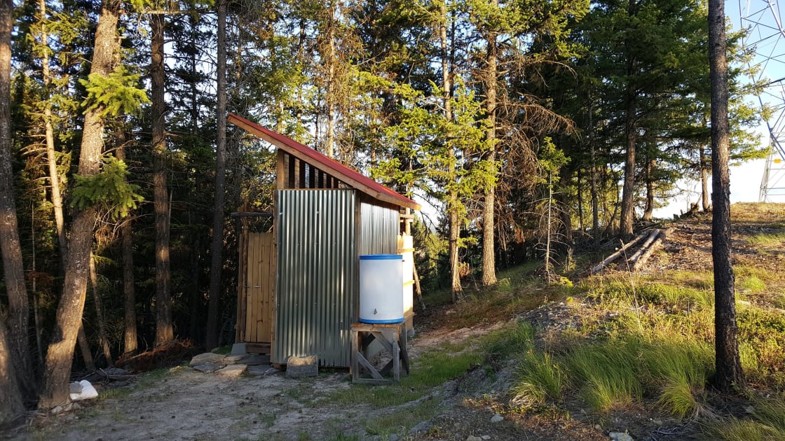 View of Out-building from campsite: Composting toilet, dry room, outdoor shower and water storage building.