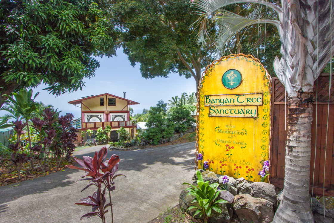 Entry sign of Banyan Tree Sanctuary and the main house beyond