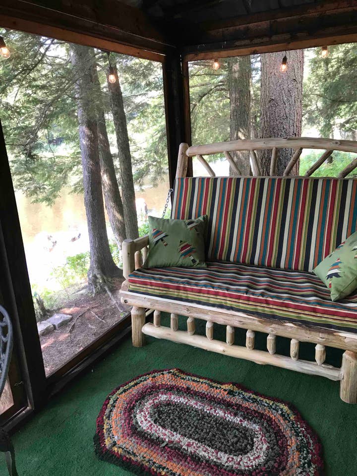 Pull out love seat turns into a double bed on the riverside porch.