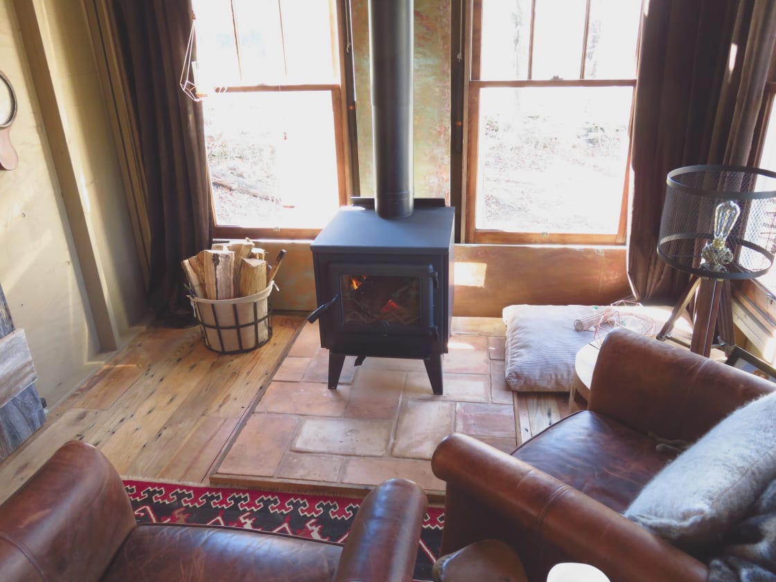 The living area features a yummy wood stove with free firewood.