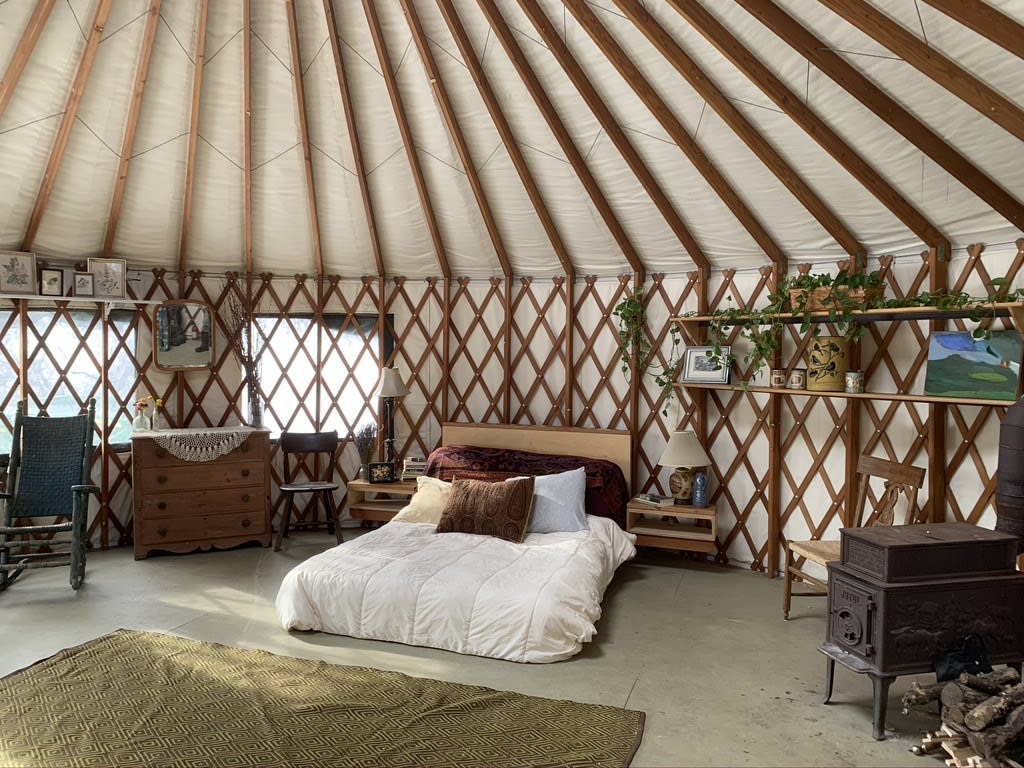 Inside the yurt, with wood stove and queen size bed