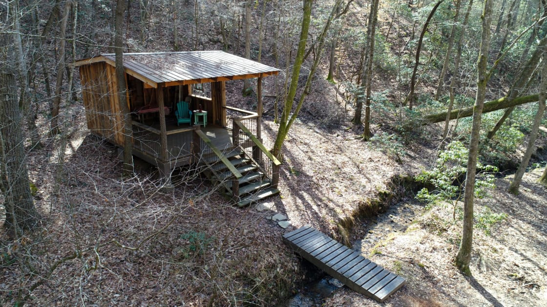 the spacious shelter sits across the creek from the main camping area and in the middle of the 12 acre heavily wooded site