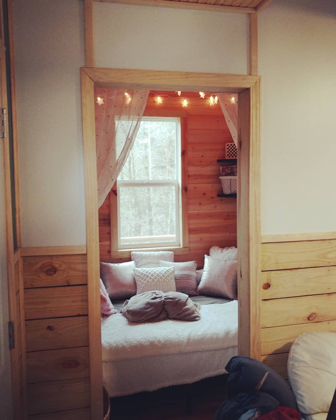 Full size bed in first floor nook that can also be a daybed