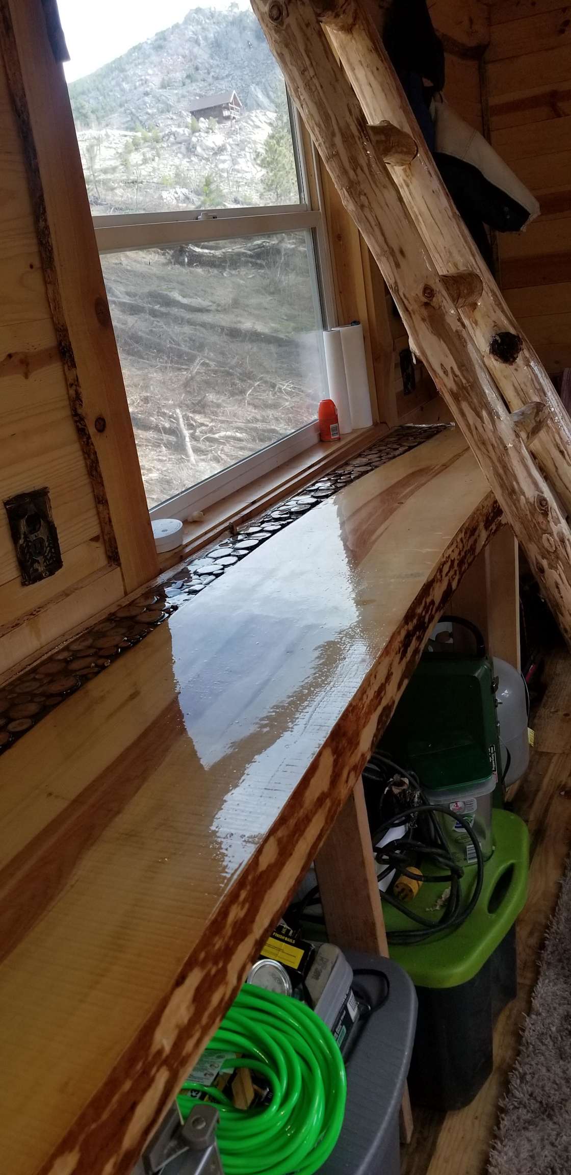 Custom counter for food prep and custom ladder to access queen mattresses in loft.