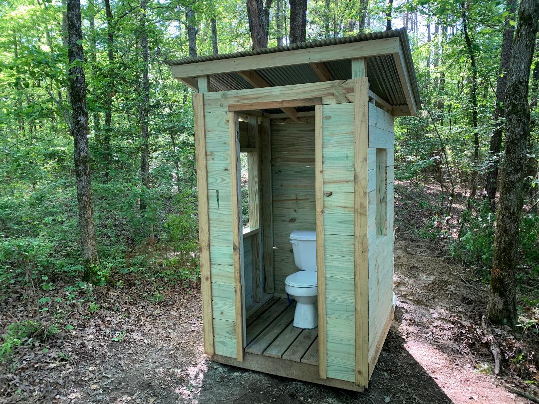 New in 2020.  Outhouse with flushing toilet!  No door yet, but who needs one when you're in the woods.  