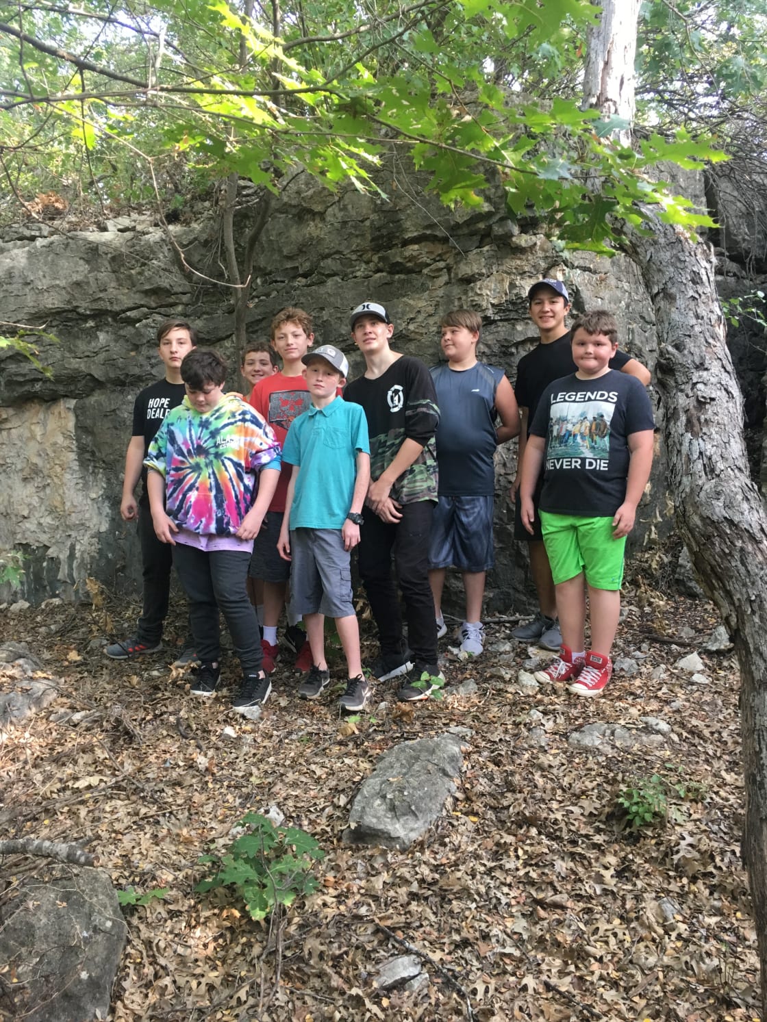 A group of campers posing near the cave.