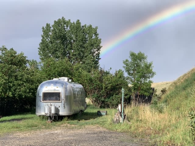 Our 1966 Airstream trailer at the beginning of the rainbow. Good signs for a fun camping season!