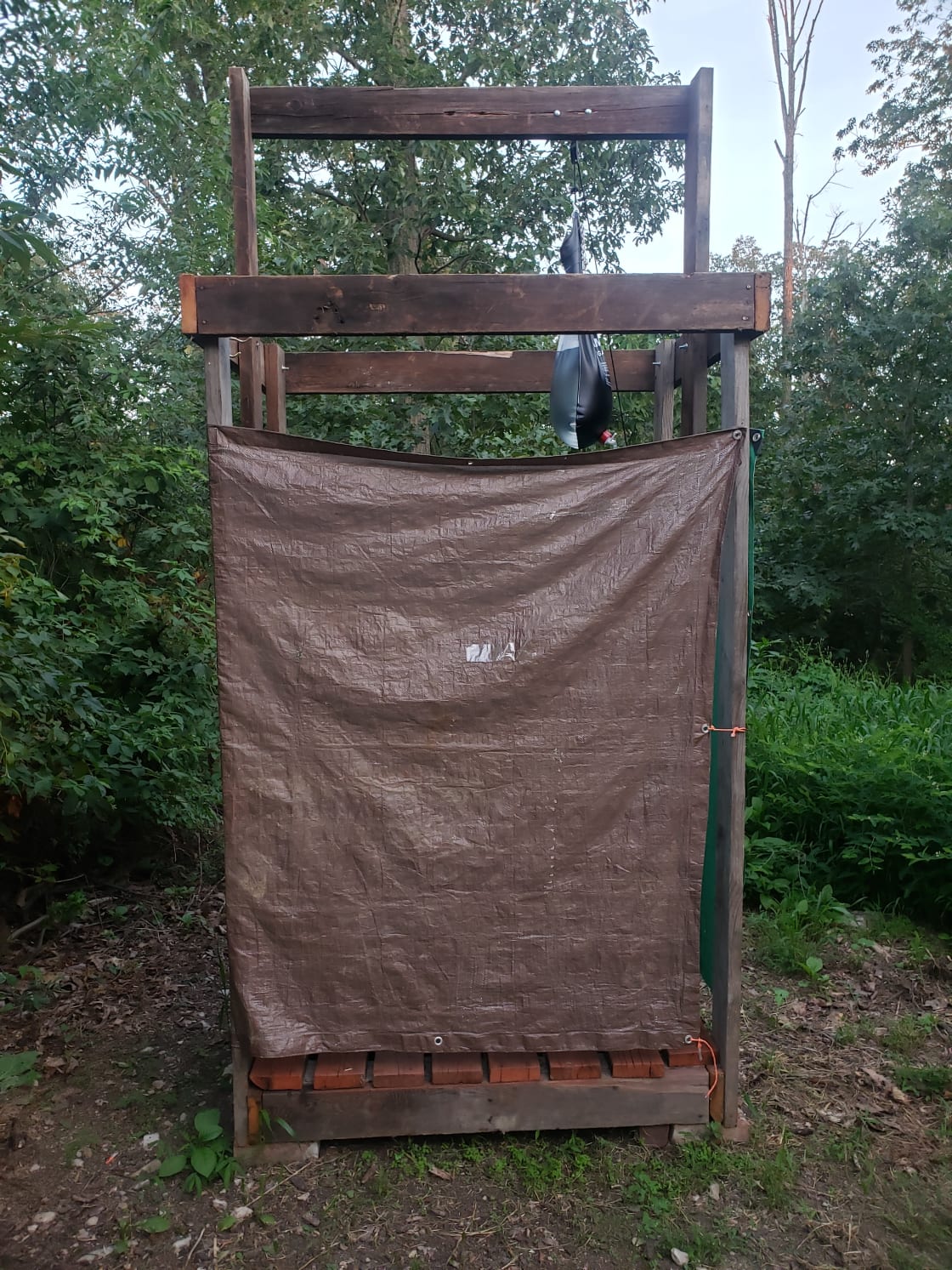This is our outdoor camp shower/ changing room. It is completely covered and private. To open it just unhook it.