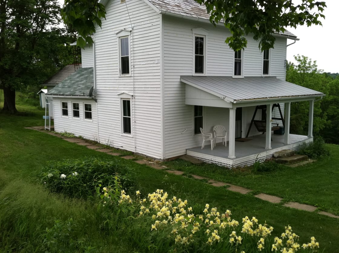 The farmhouse has a large covered porch with wonderful views of the farm.