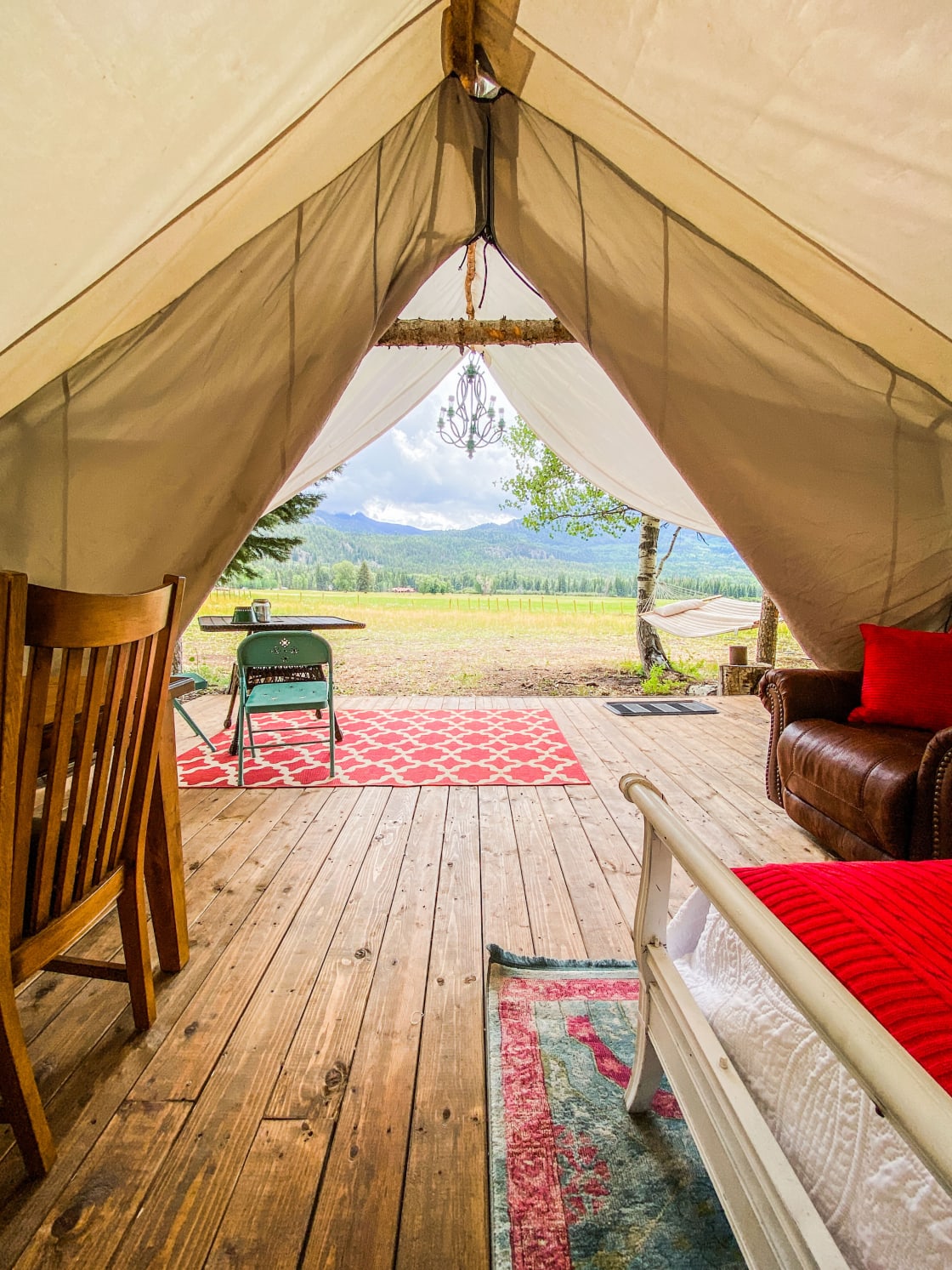 Caruso Tent [sleeps 6] outfitted with two queens and two twin beds featuring luxury linens, soft bath towels and battery-operated candles. Bring flashlights for additional lighting.