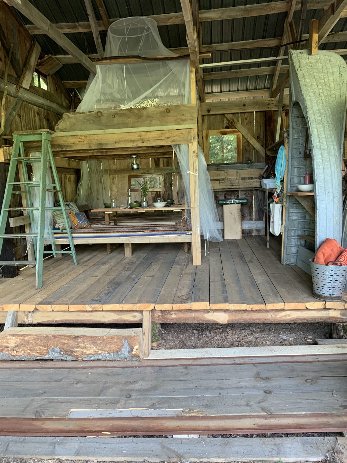 Step into the open barn, into the rustic setting with table and bench seating, countertop for cooking prep as well as cooking stove provided (if you didn’t want to cook on the fire), and best of all, a sleeping loft. All to keep you protected from weather!