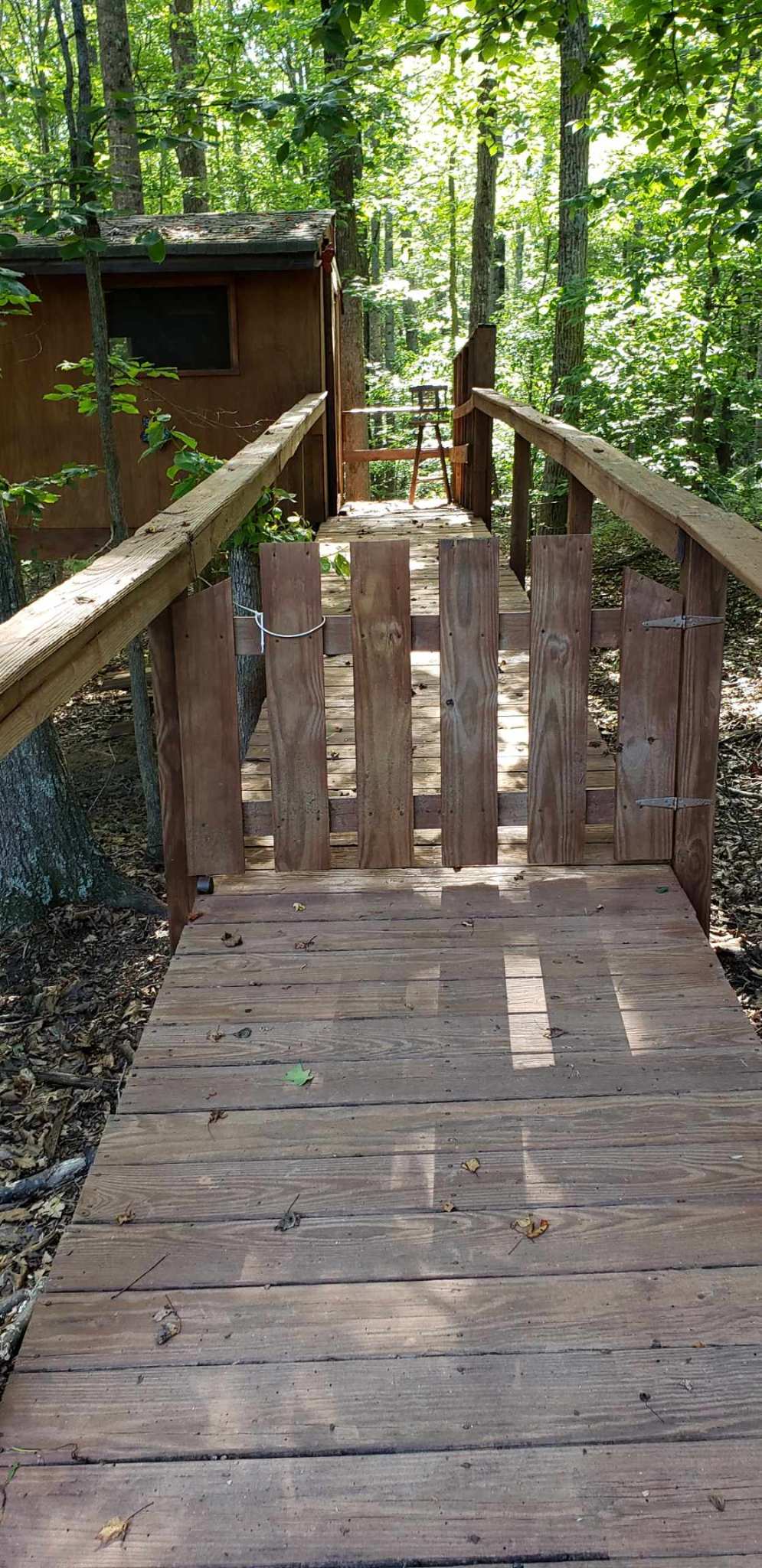 Ramp to treehouse with a gate.