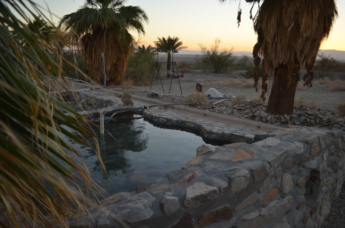 Ready for soaking after cooling down to 110 degrees. Pool built from local rocks and surrounded by native palms.