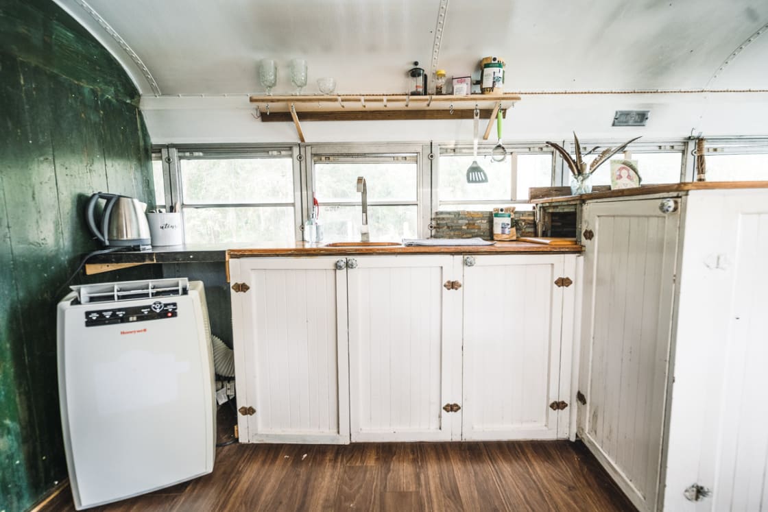 Cute kitchen space inside the renovated bus,