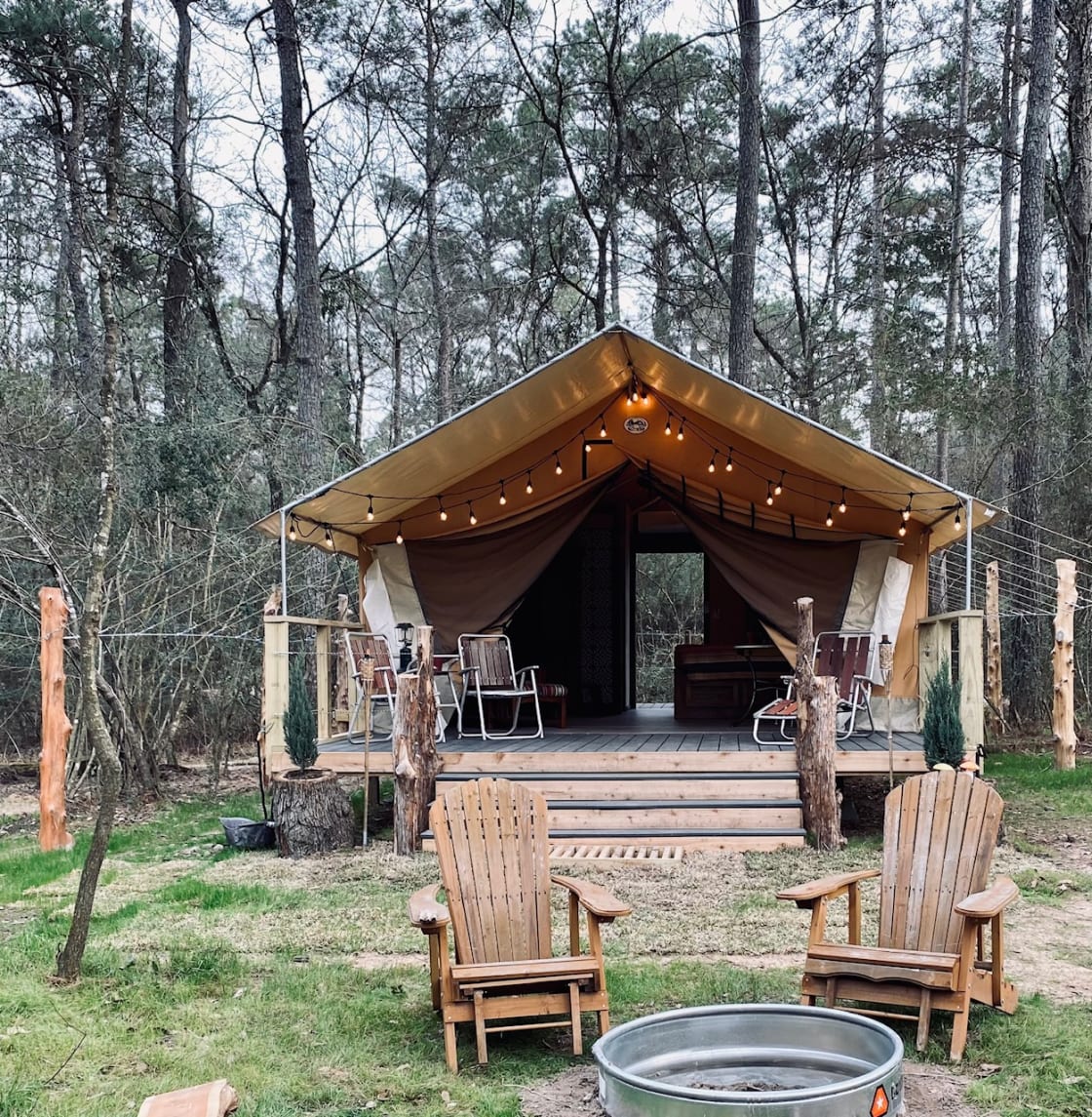 Our luxury tent has a front and back porch, a back screen door, a bathroom, mini-split HVAC, a ceiling fan, WiFi, assorted teas, coffee, snacks, a fridge/freezer, a microwave, a queen-size bed, night-stands, mid-century table and chairs and so much more.