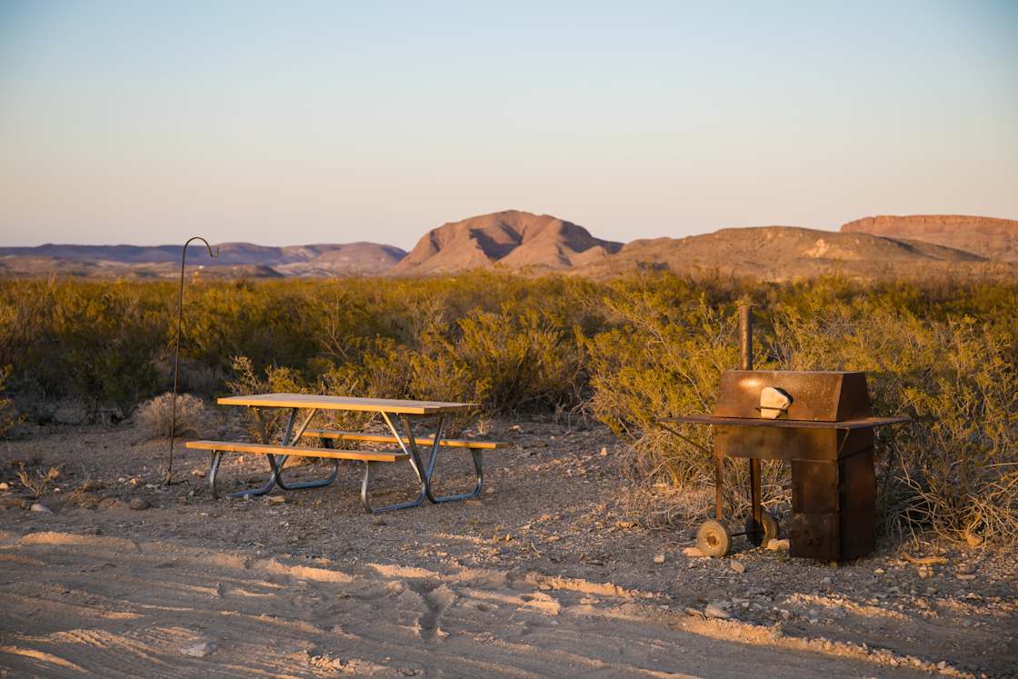 Picnic table, lantern hook, and grill