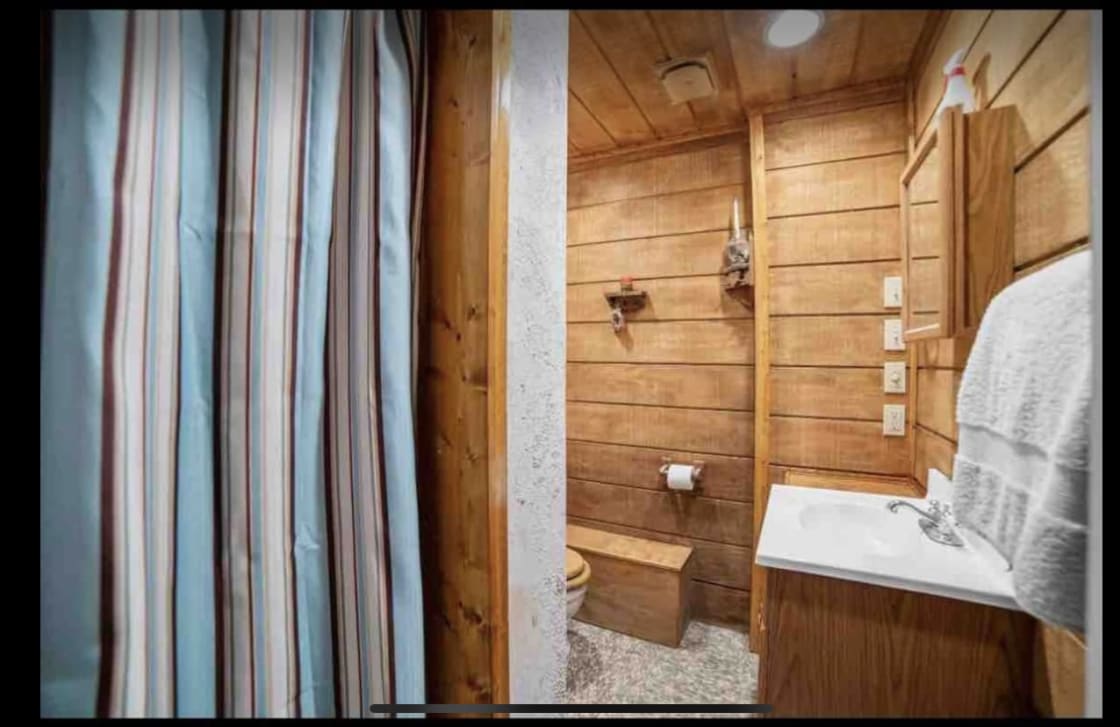 This is the cute bathroom that is in my basement you just go through the garage and the Airstream it's going to  be parked right next to it and then you can go in and use the bathroom it's got a shower and toilet and sink!