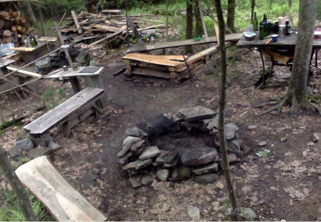 Main campfire ring.  With grills, wok stand, and coal-cooking side-access.  The dish-washing station and cabin-side outdoor kitchen are close by.  Other fire rings exist for private campfires and additional cooking options for multiple groups.  