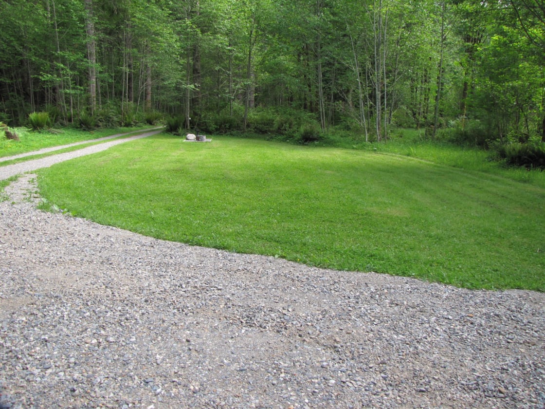 Grassy area for additional Tents, small RV's & Trailer parking, Campsite is 100' down the trail to the right.