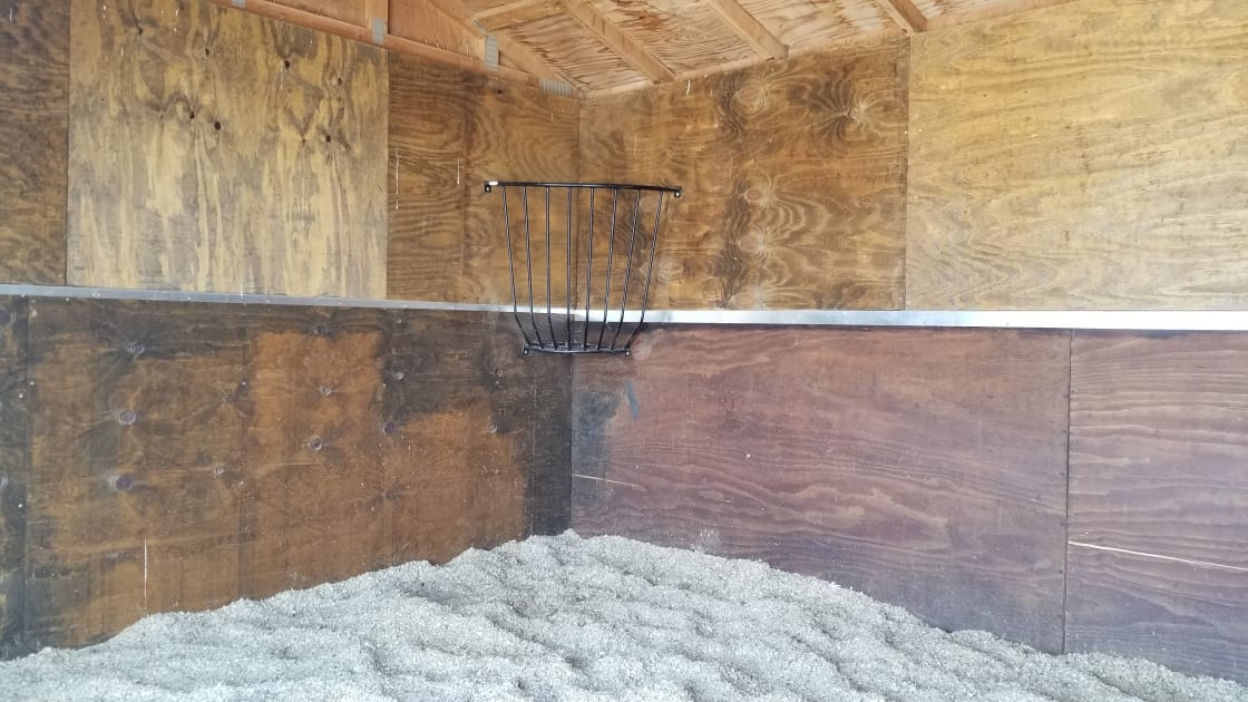 12 ft x 12 ft matted shelter with hay rack. Can be closed or open to the pen. 