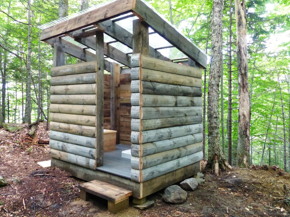 Newly built bath house with pit toilet and shower
