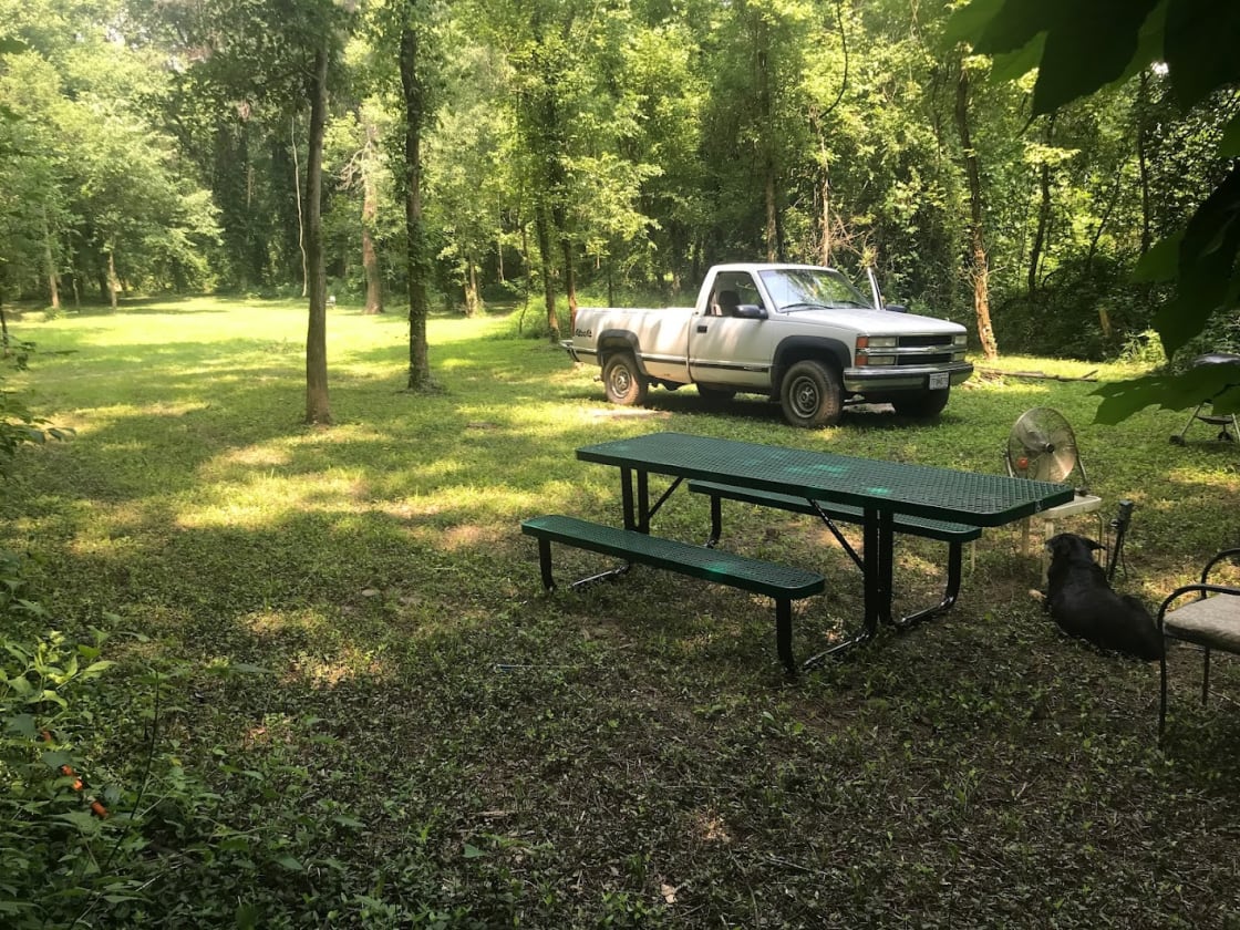 This is site 2. This site has the most open grassy area for a larger group or for playing frisbee, horseshoes, or stargazing. SIte 2 also has a large picnic table, a garden hose for water, a 110v electric outlet, a fan, and a Weber bbq kettle.
