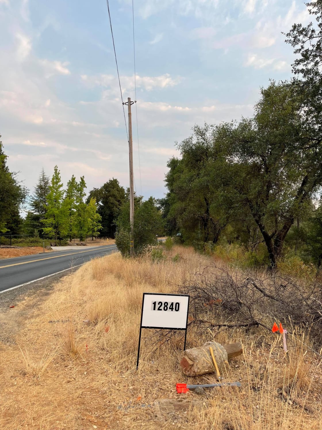 Address next to dirt road down to flat area of property