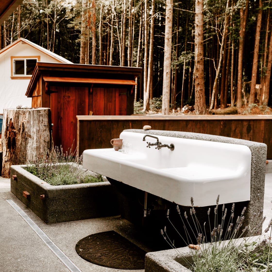 This sink near the bath house has hot and cold water and is framed with a lush herb garden. Pick what you need! 