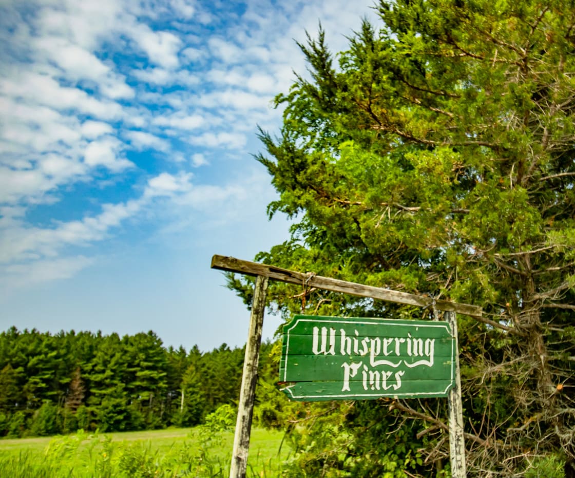 The front entrance sign to Whispering Pines